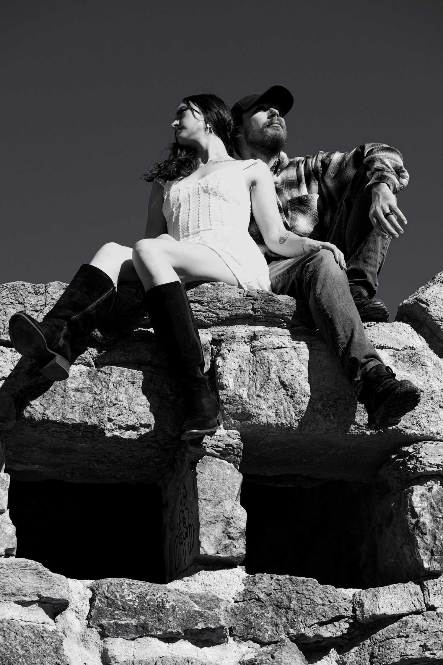 Black and white photo series showing intimate moments on stone steps.