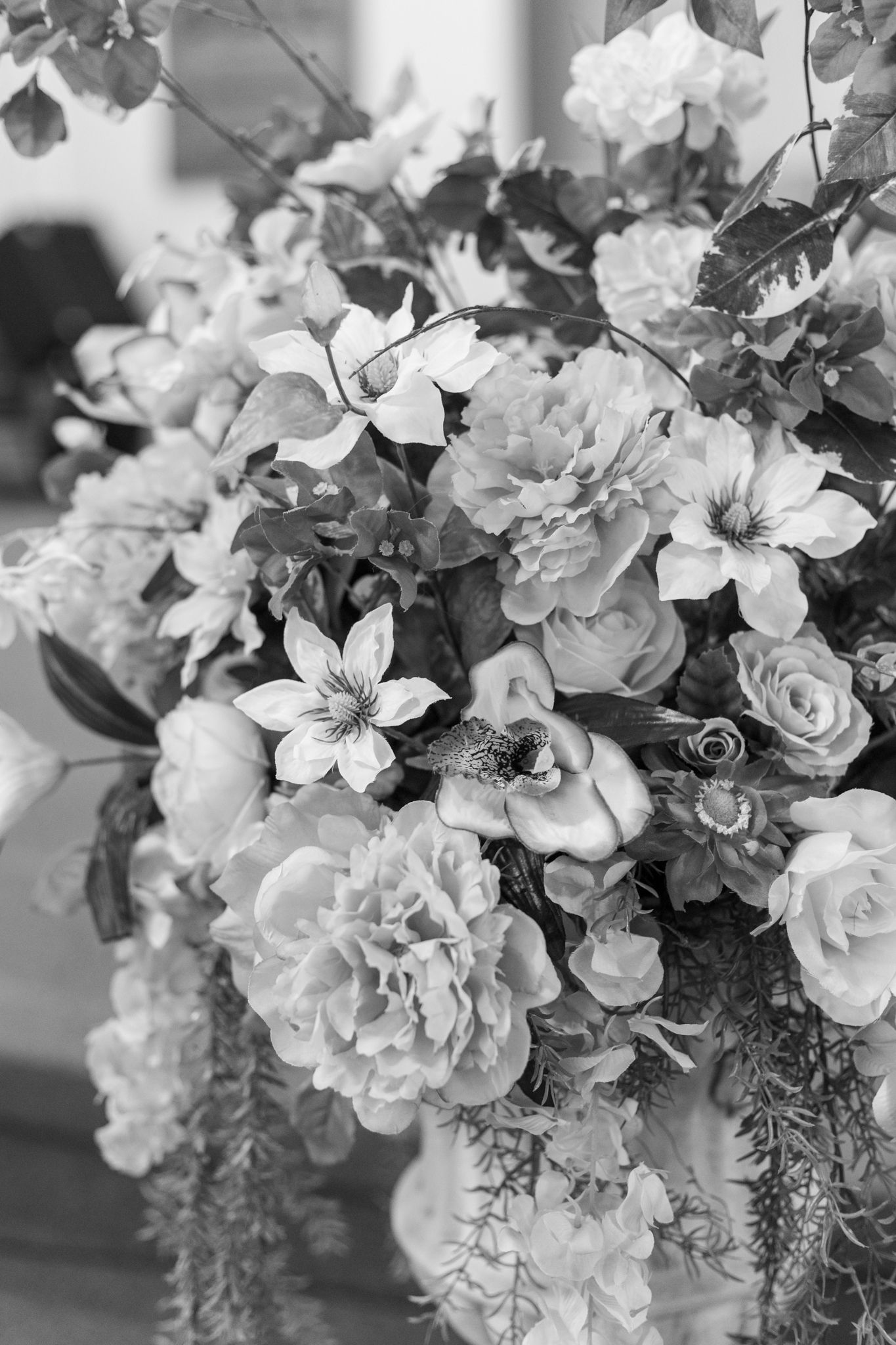 Black and white floral arrangement with roses and mixed blooms in an elegant display.