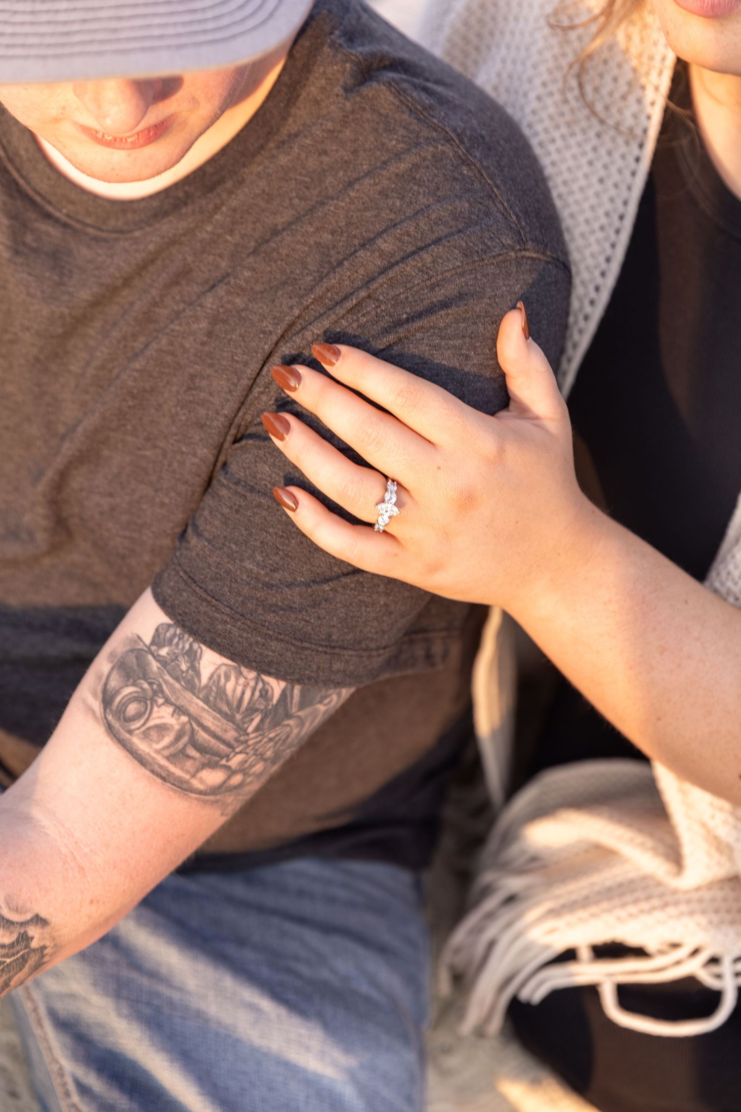 A close-up sequence of hands holding a gray t-shirt showing various angles and positions of the garment.