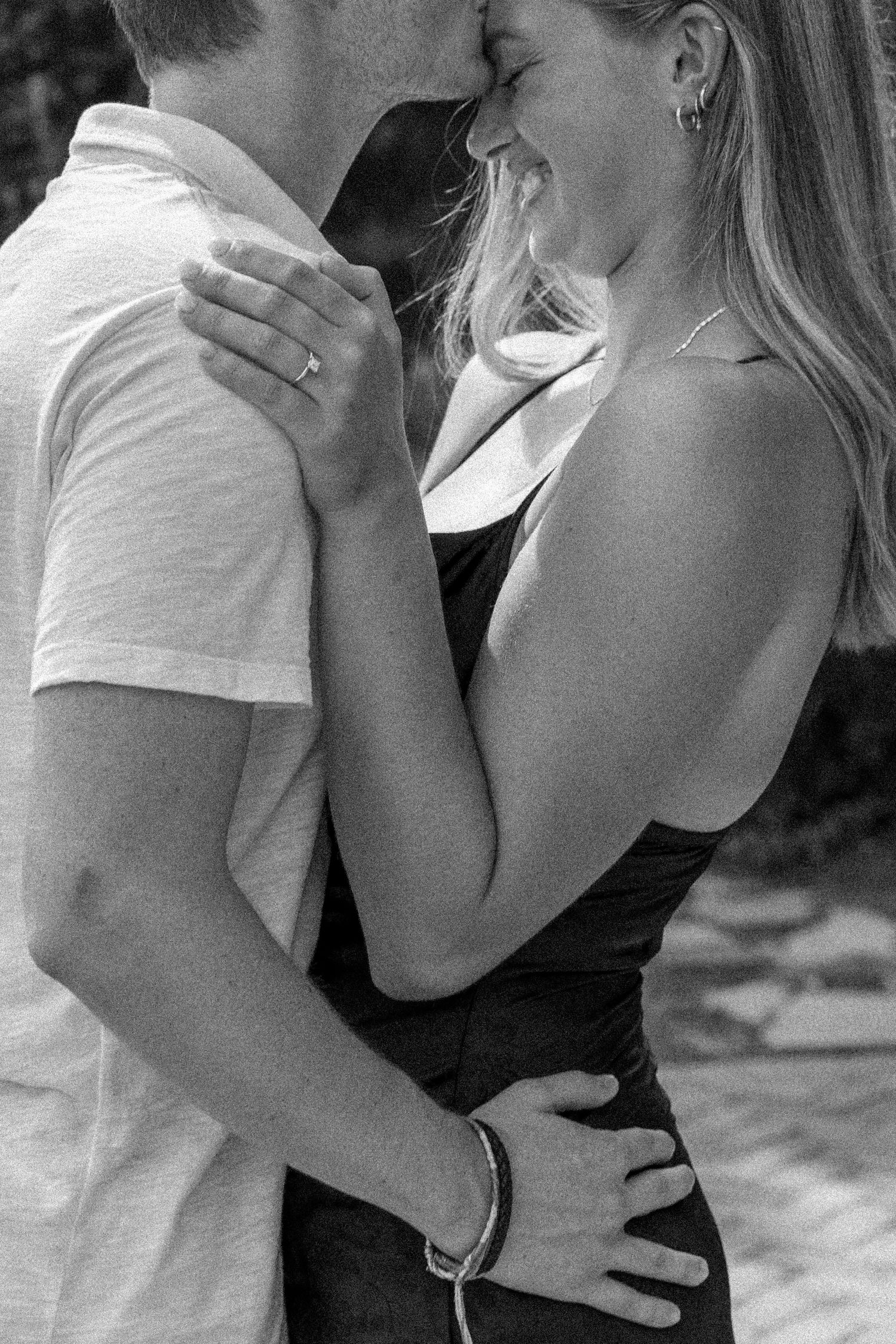 Black and white intimate portrait of a couple sharing a tender romantic moment.