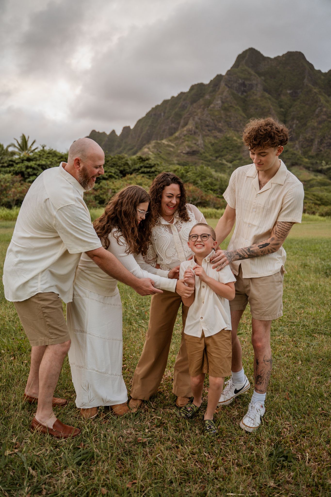 A family shares a joyful moment together with mountains in the background.