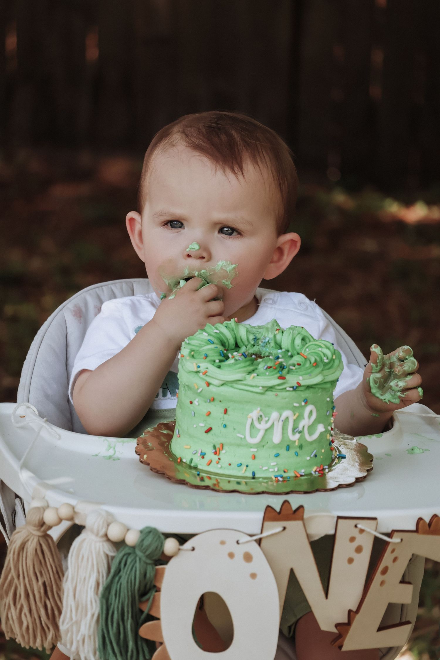 First birthday celebration with mint green smash cake and decorative ONE display.
