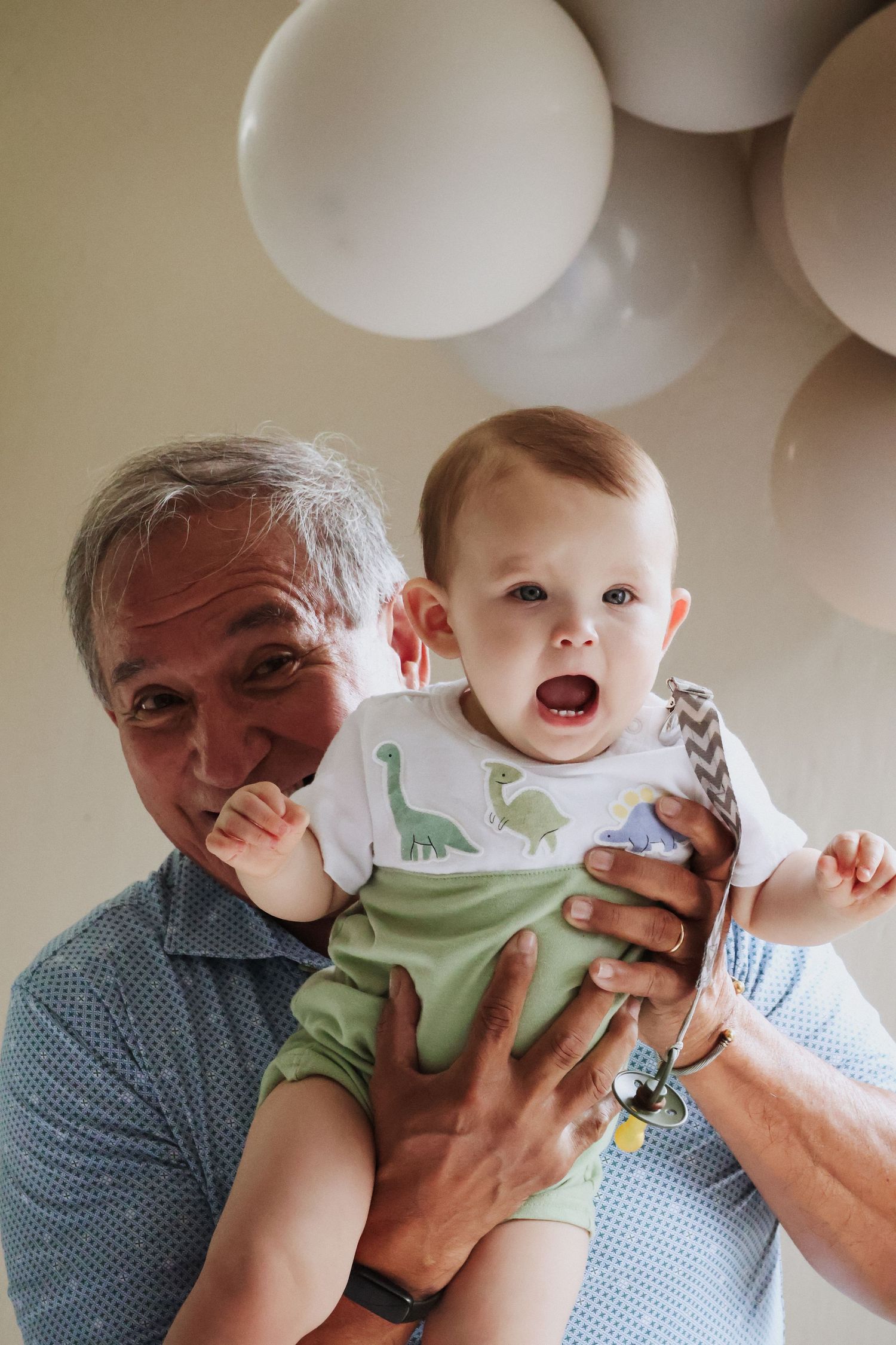 A heartwarming moment with balloons decorating the background.