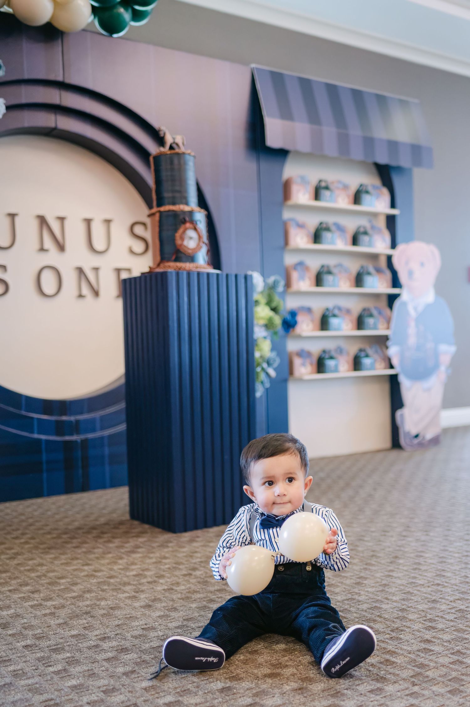 Event space with blue wall panels and patterned carpet showing playful moments.