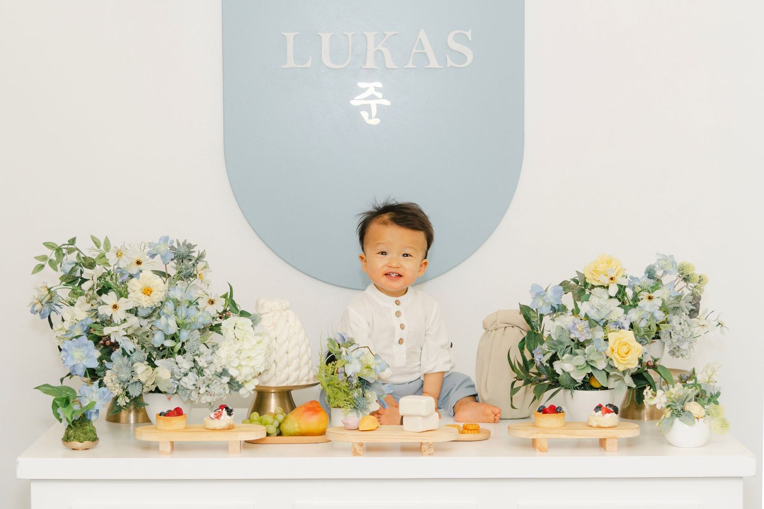 Event space featuring 'LUKAS' text on wall with white and blue decorative elements.