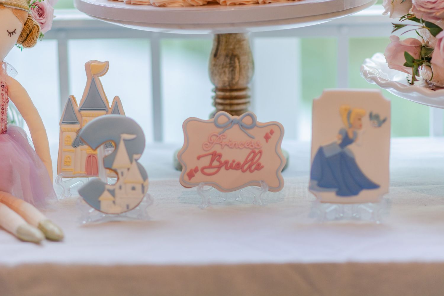 Pink and blue party decorations with balloons and cutouts create a festive baby shower or gender reveal setting.