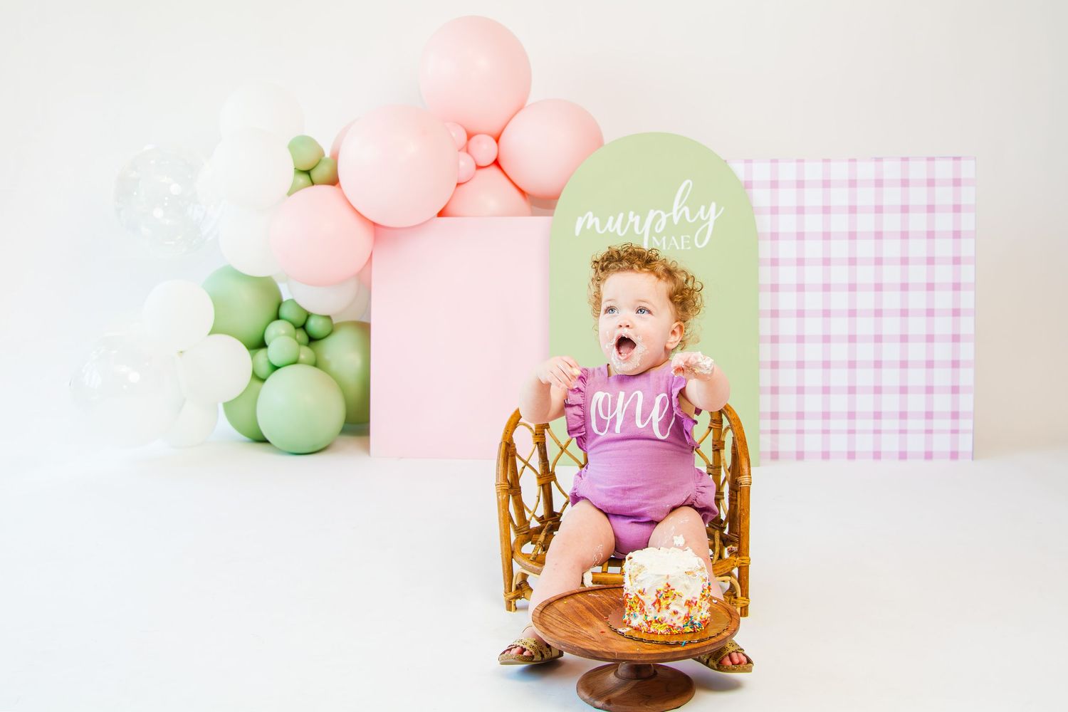 Pink and mint themed birthday party setup with balloons and decorative elements.