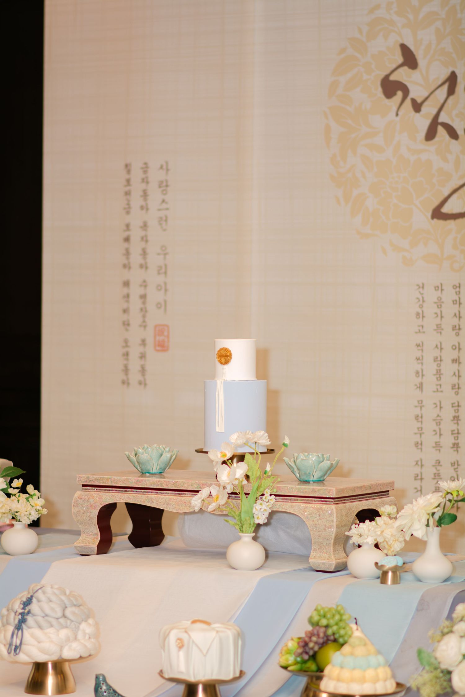 Elegant wedding reception table setup with white flowers and blue accents.