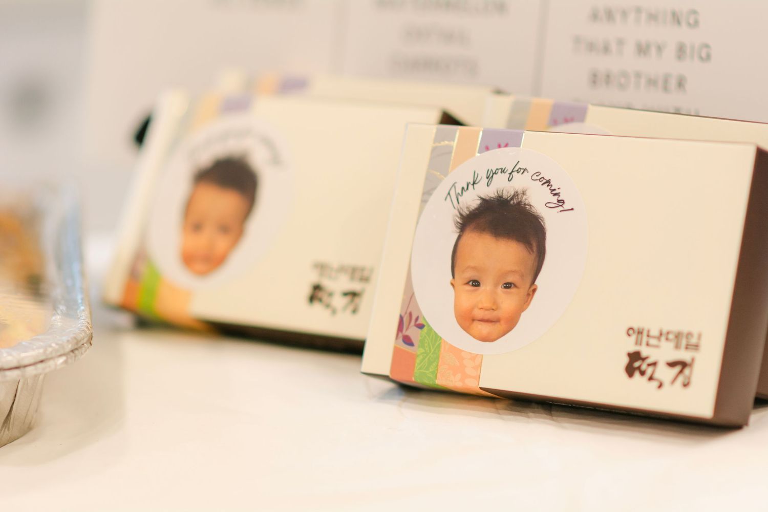 Close-up of personalized celebration cards and party favors arranged on table.