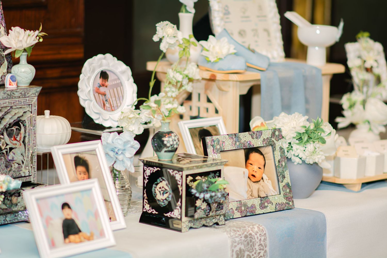 Wedding reception detail shots showing framed photographs and decorative elements in soft lighting.