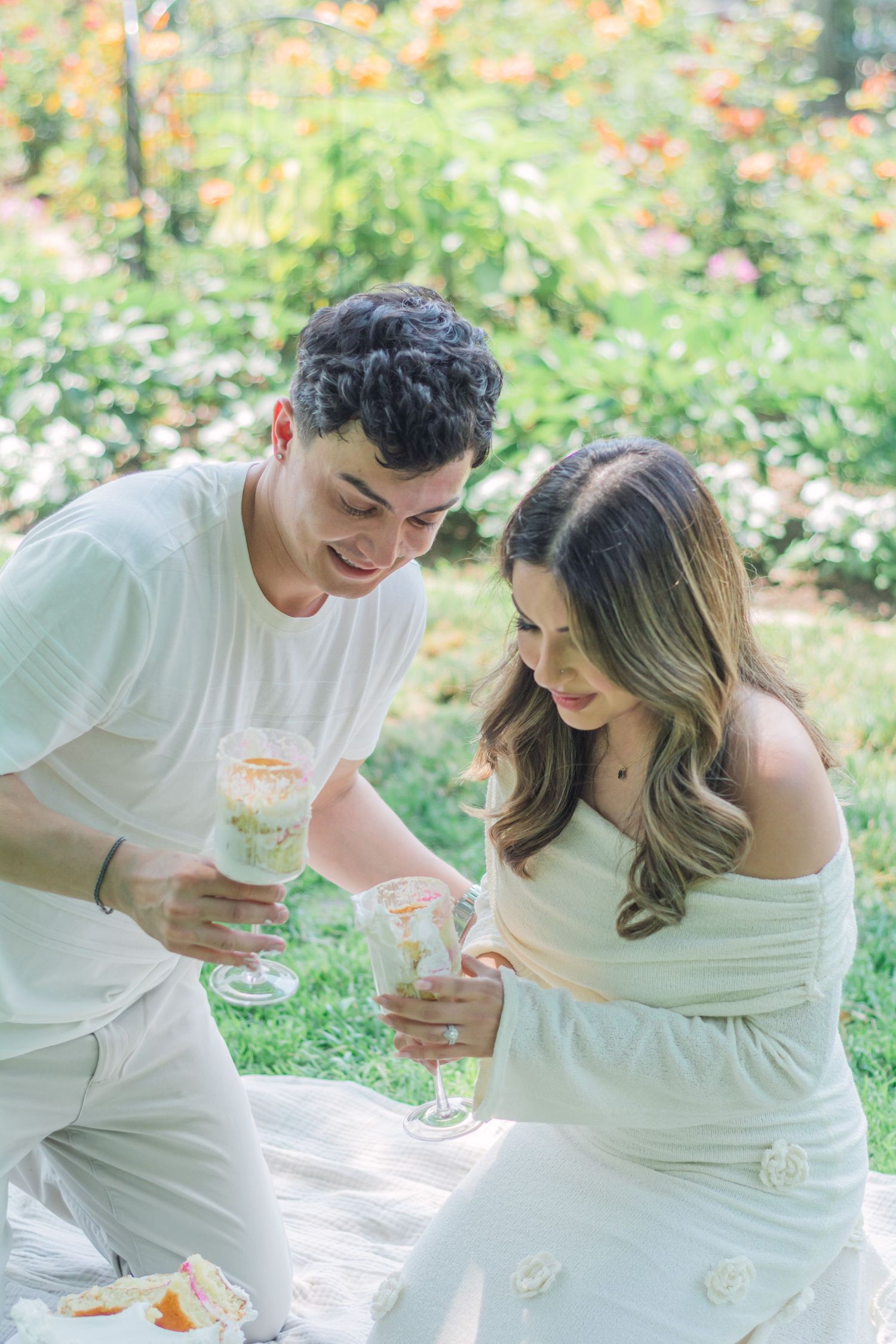 Candid pregnancy announcement moments captured in a blooming garden setting.