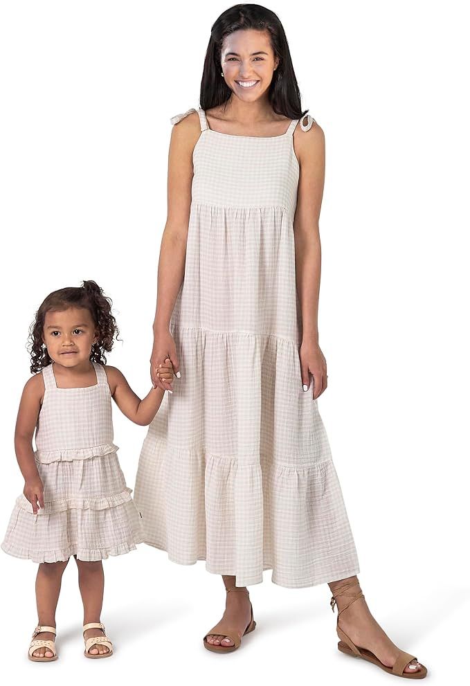 A matching beige gingham tiered dress set for adults and children with shoulder ties and sandals.