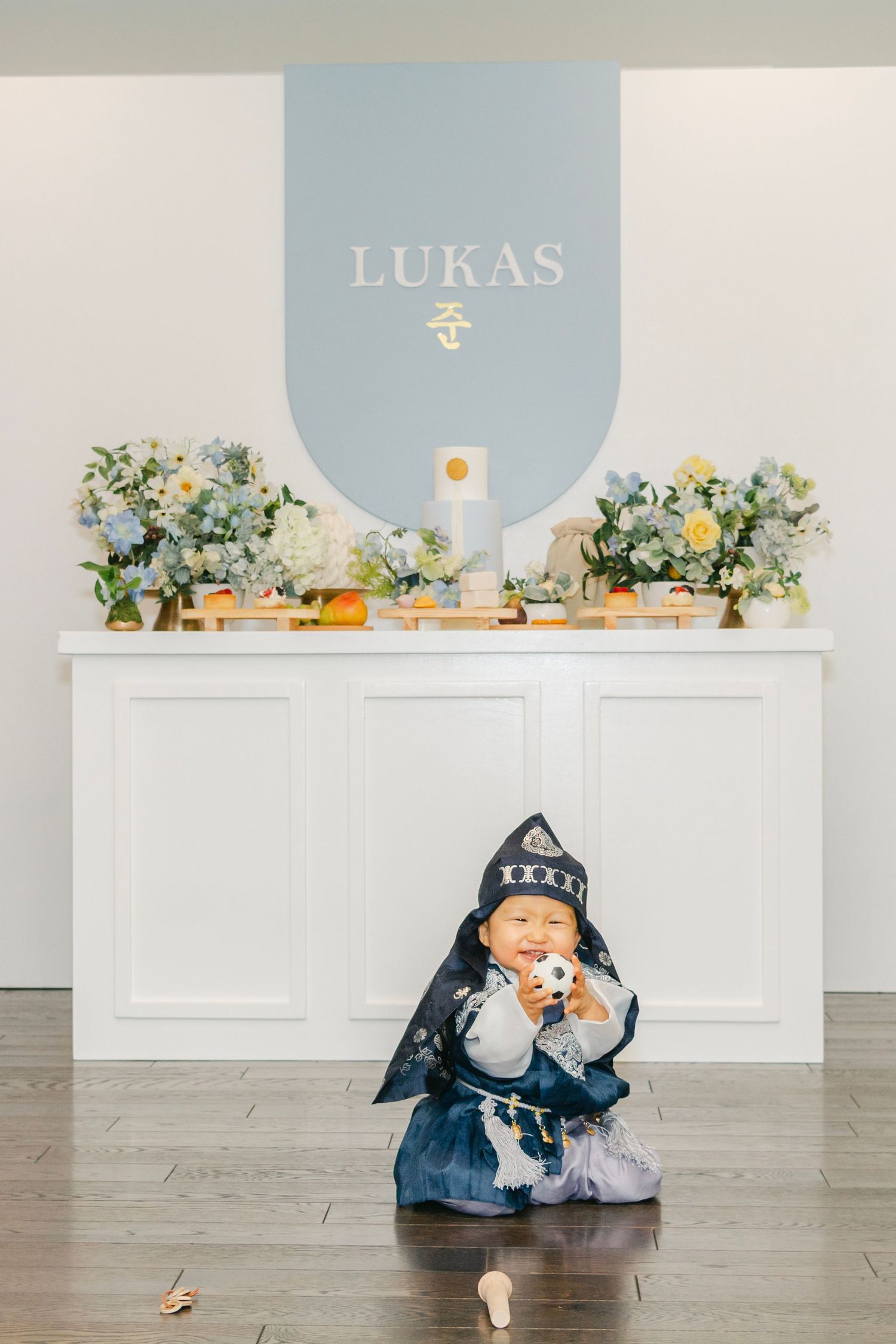 Event space with toys on floor against white furniture and blue accent wall.
