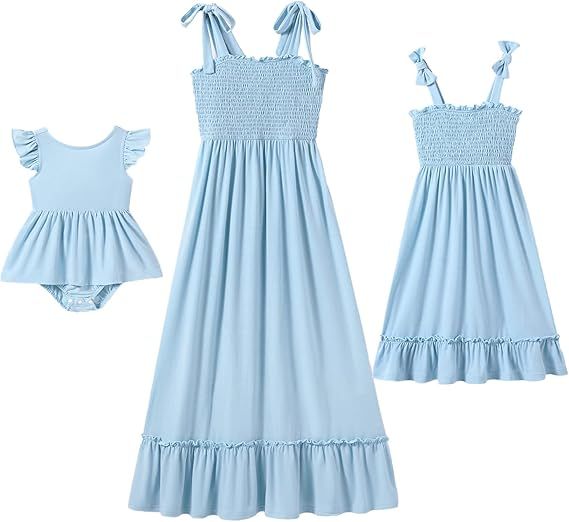 Collection of light blue smocked dresses and rompers for babies and toddlers arranged in a horizontal line.