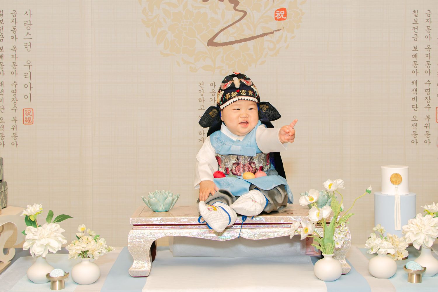 Asian-inspired studio portrait session with traditional elements and floral decorations.