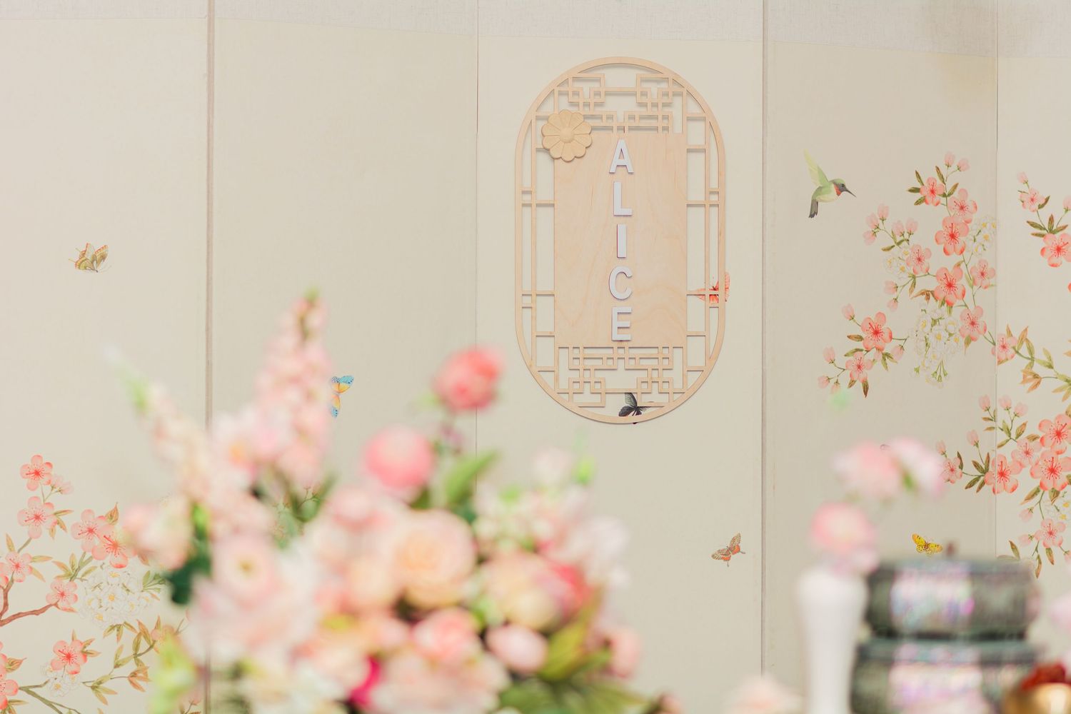Delicate wall design with cherry blossom motifs and ornate window frame.