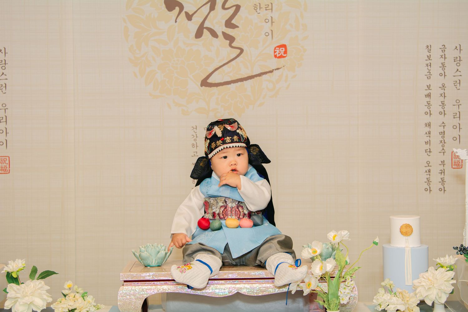 Traditional dol party display featuring blue and white decorations with oriental design elements.