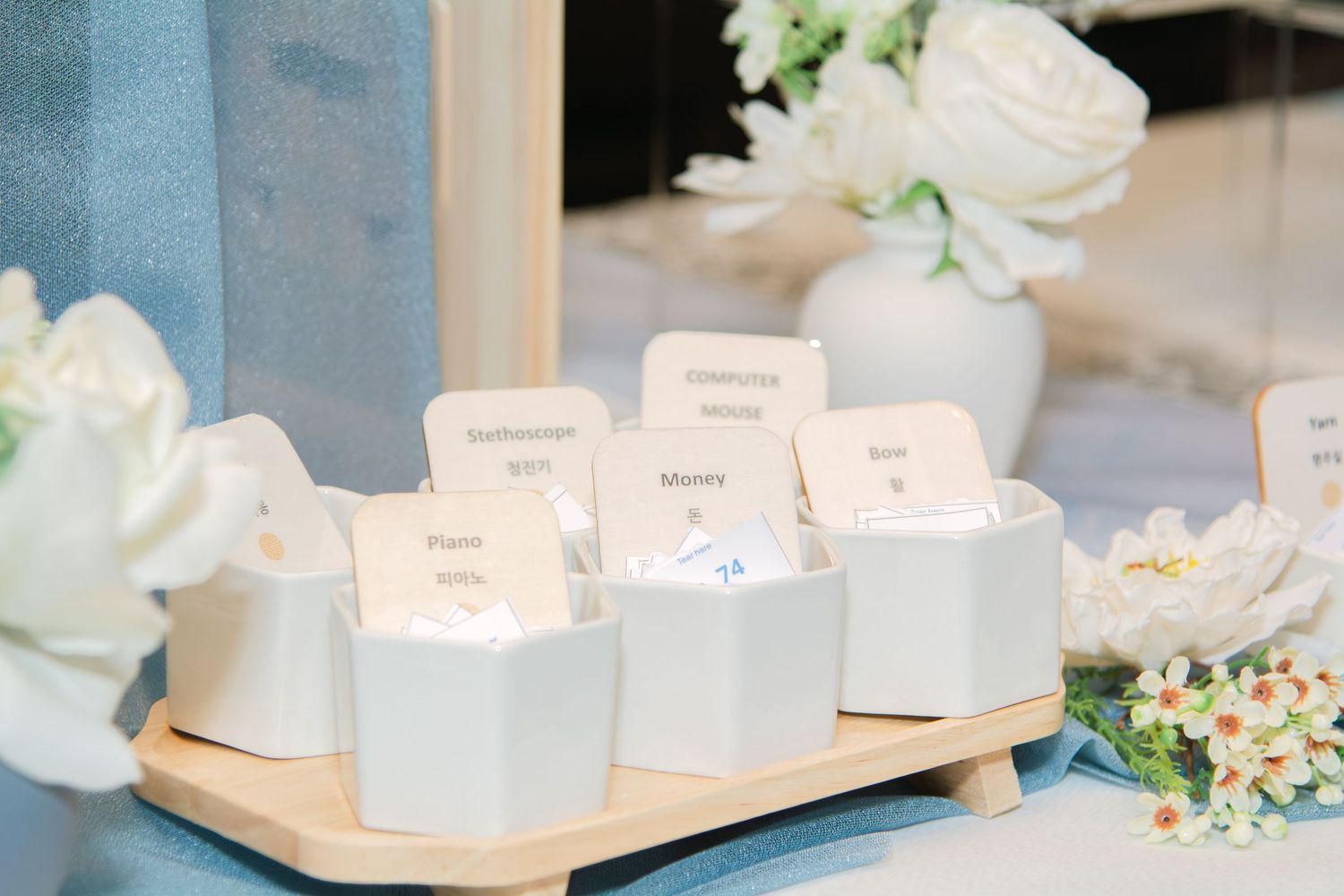 Close-up of white decorative elements and floral arrangements on wooden surfaces.