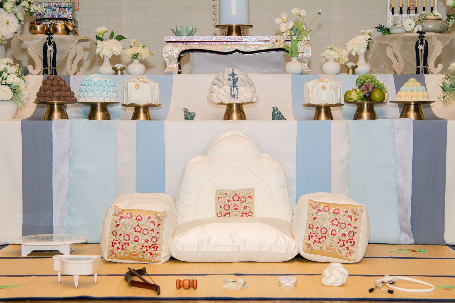Series of traditional Korean dol party dessert tables with blue and white themed decorations.