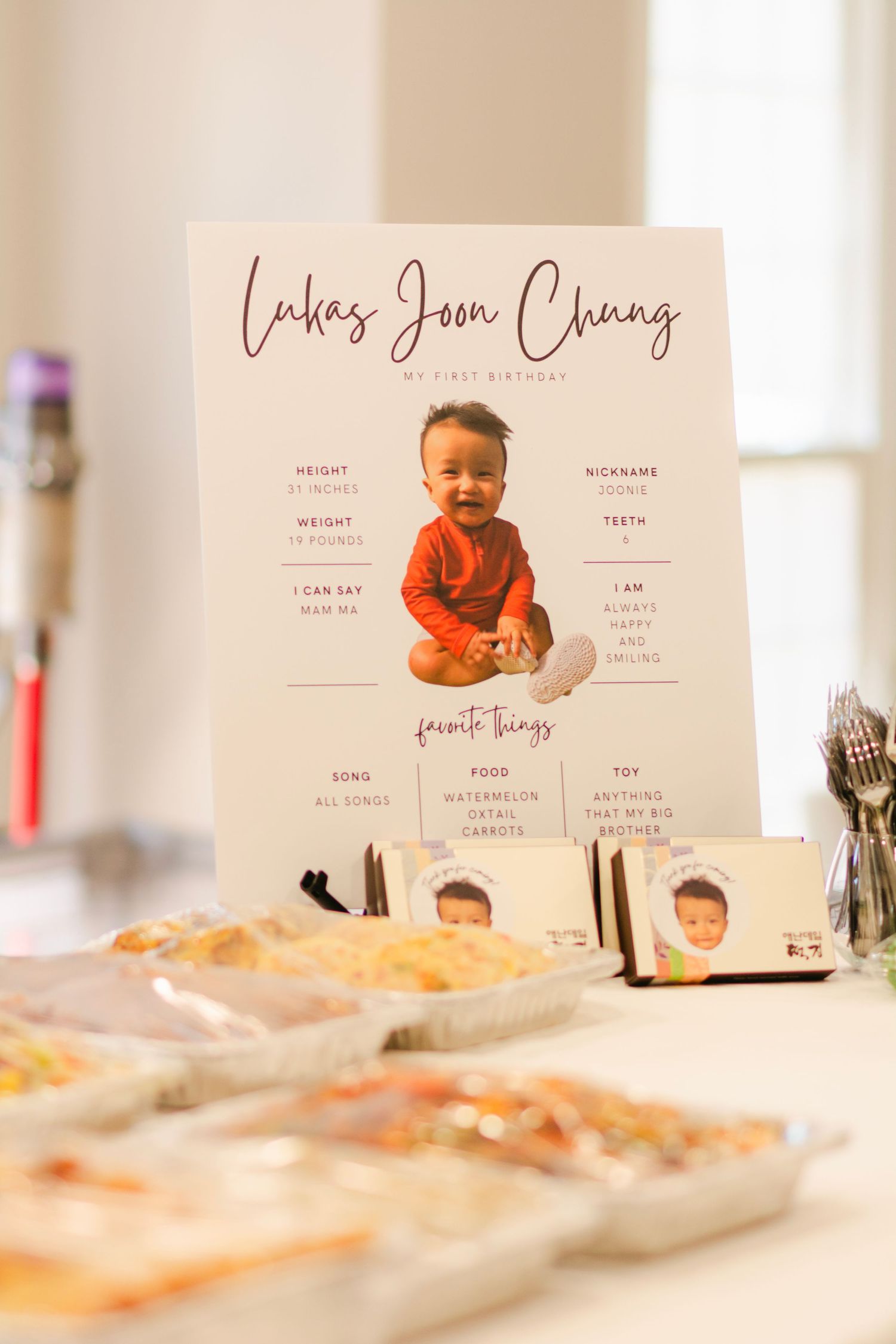 First year celebration display with name cards and decorative details on cream colored table.