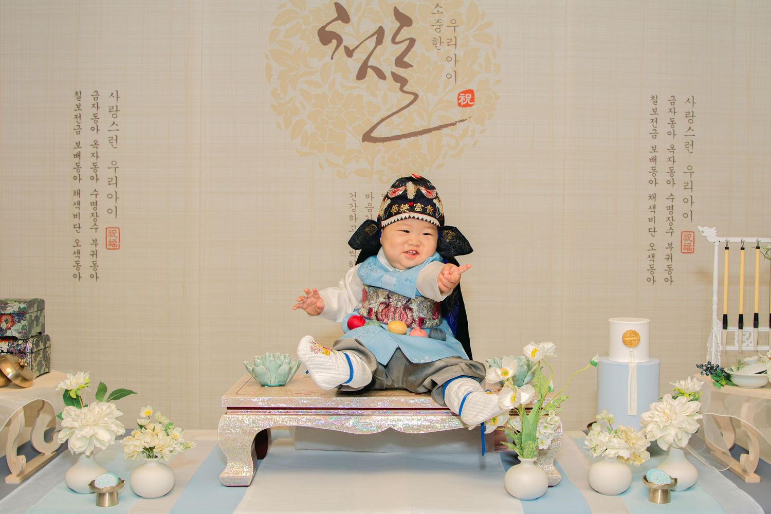 Wedding reception setup featuring illustrated characters and Asian-inspired decorative elements on display.