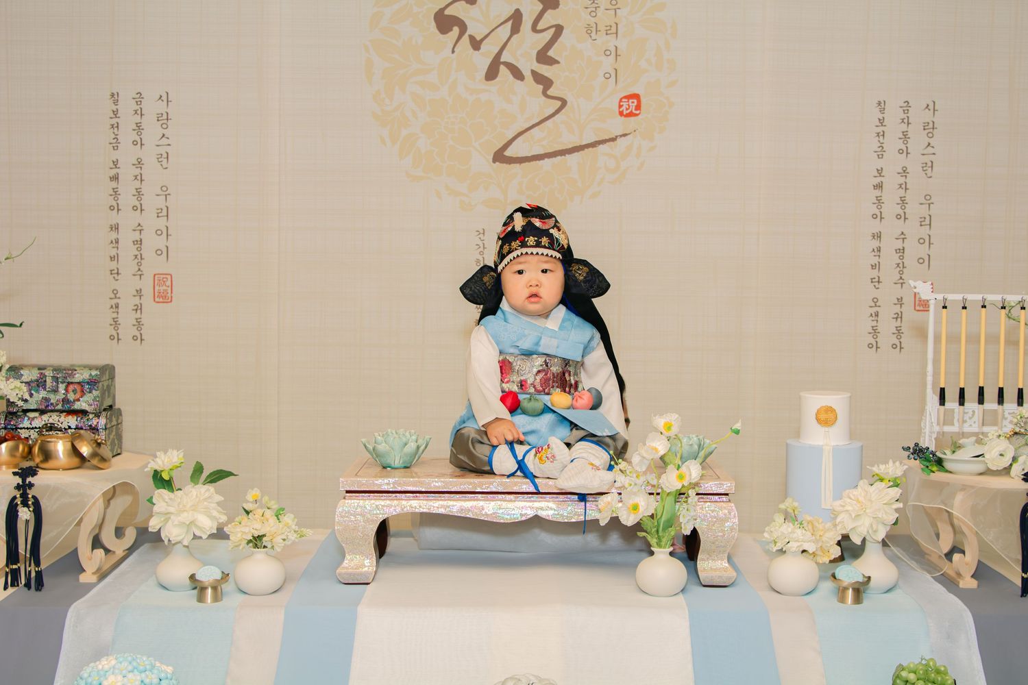 Traditional Korean themed party decorations featuring delicate blue and white elements with paper designs.