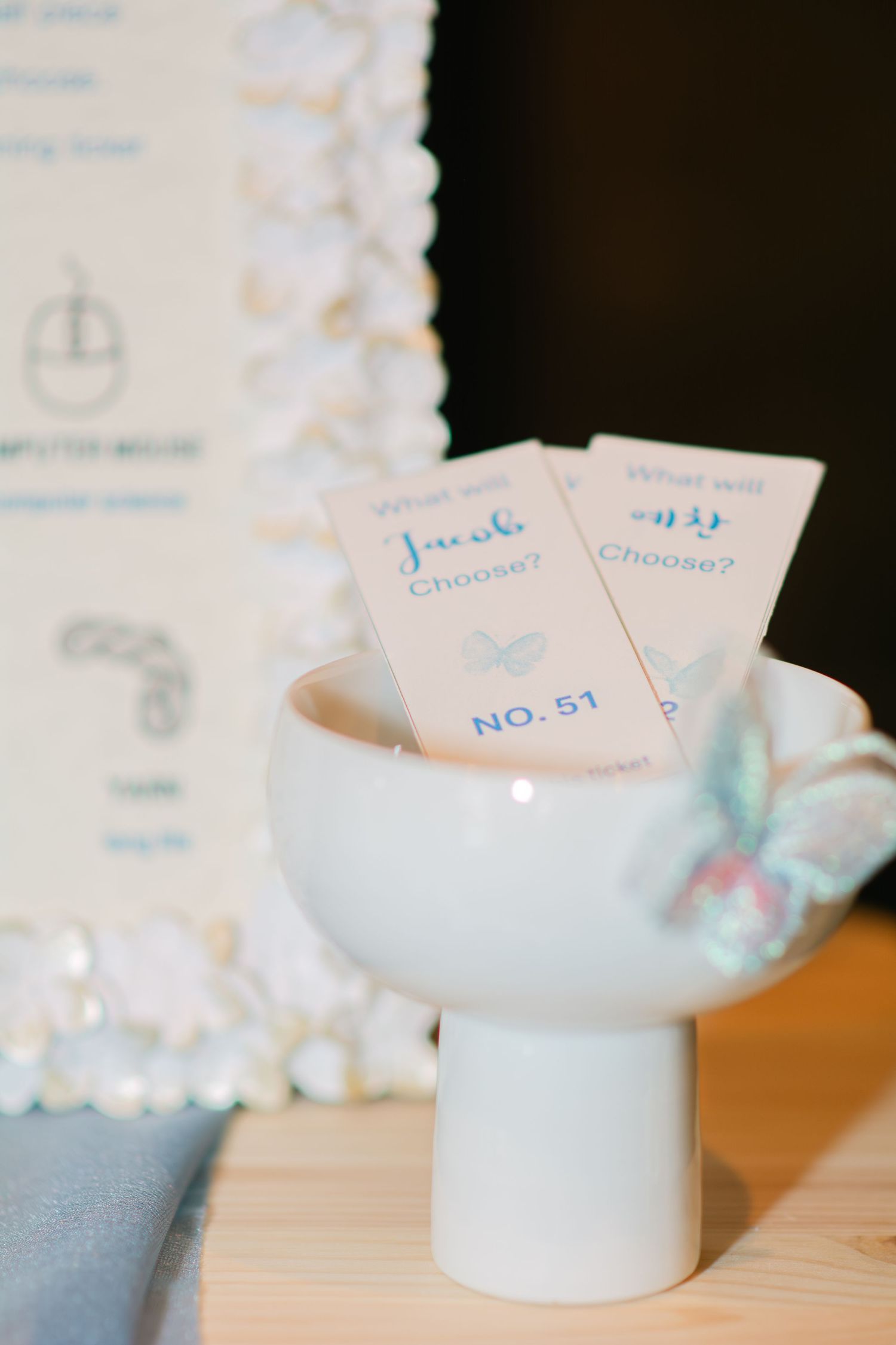 Close-up of light blue ceramic decorative pieces with numbered cards.