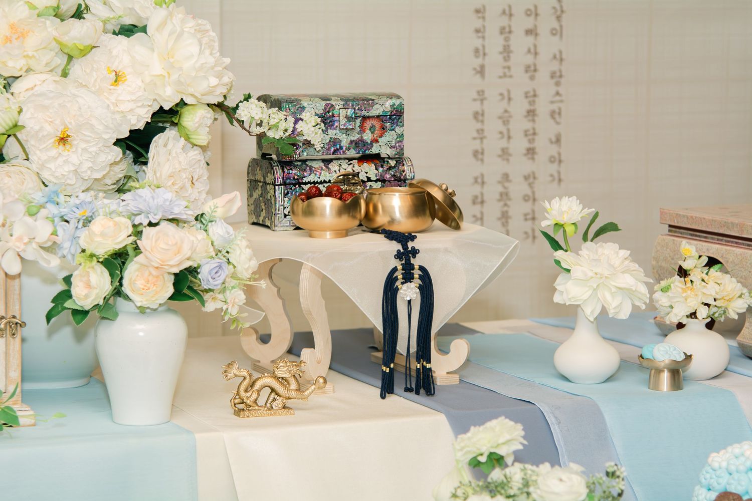 Minimalist party decor with white flowers and powder blue design elements.