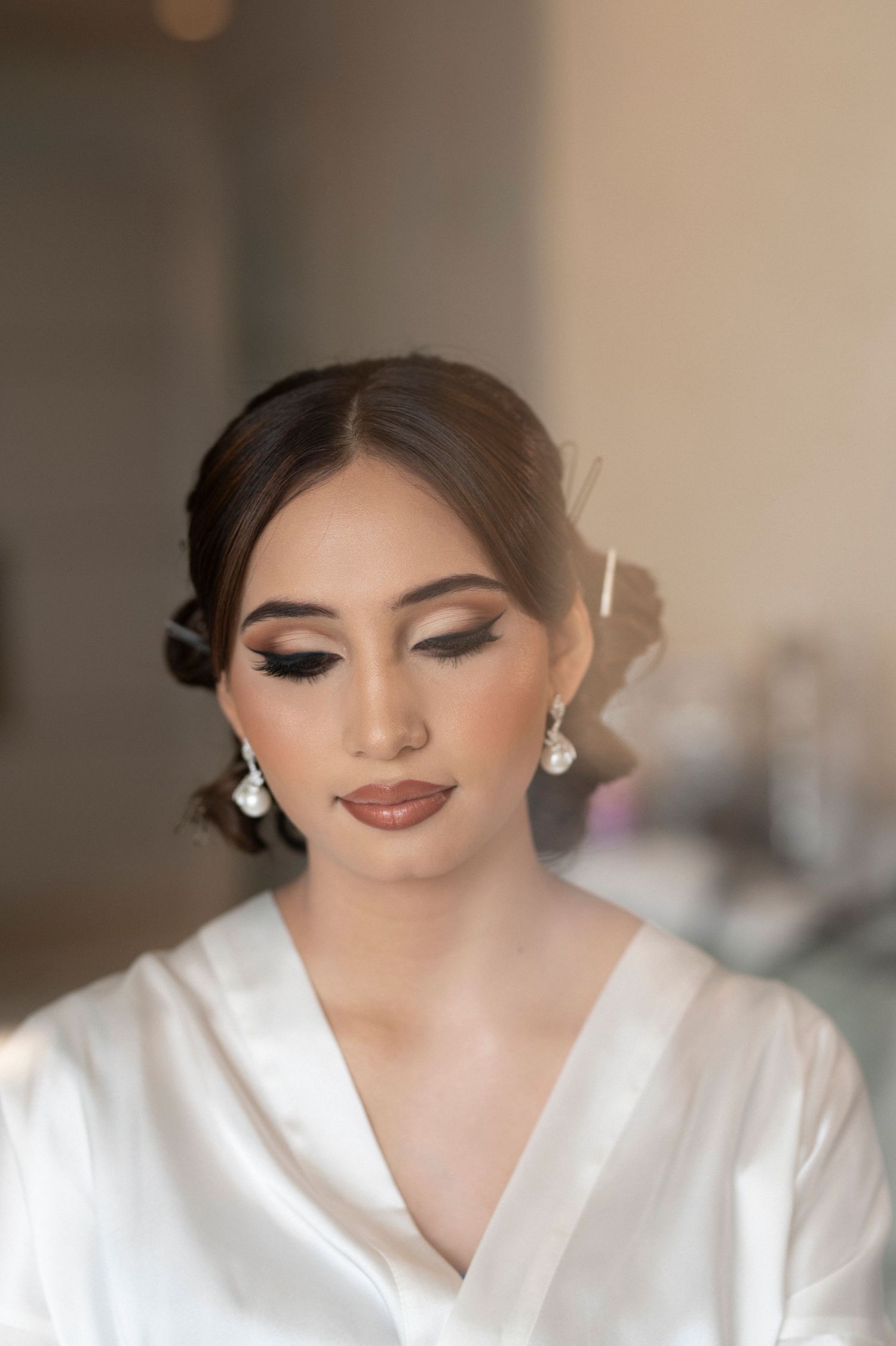 Close-up bridal beauty shot showcasing soft glam makeup and elegant updo.