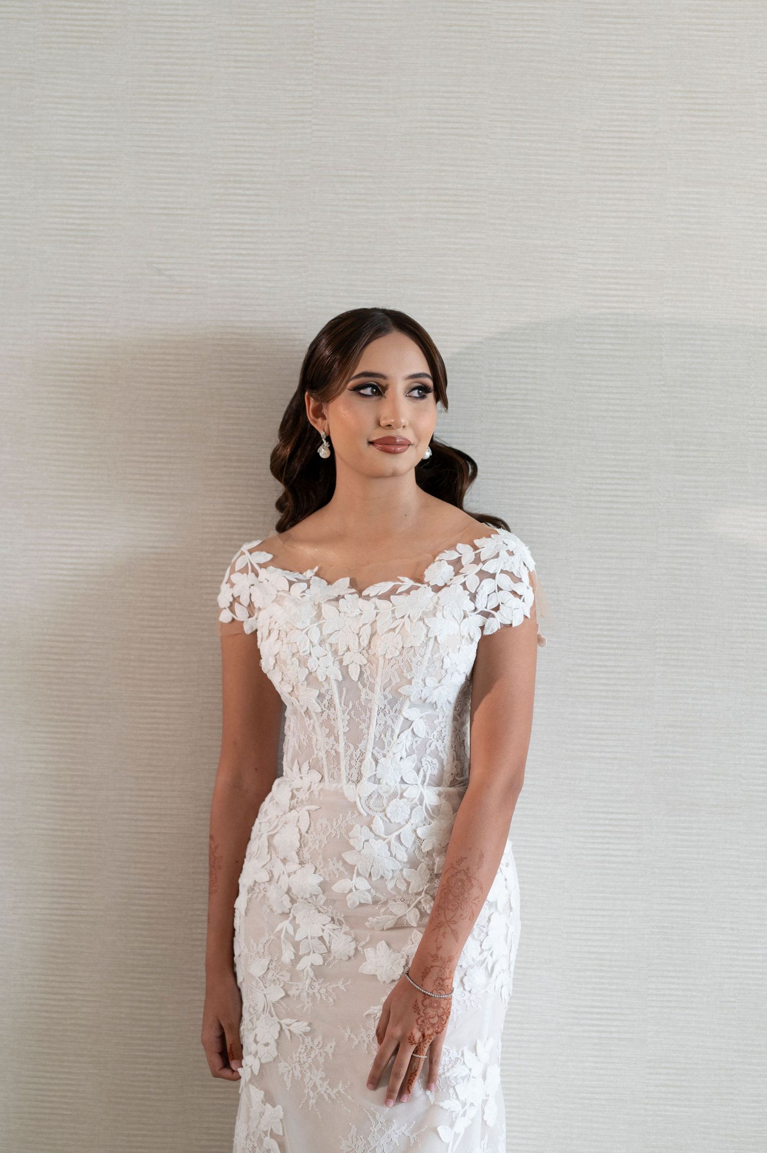 Lace wedding gown with cap sleeves and floral appliques.
