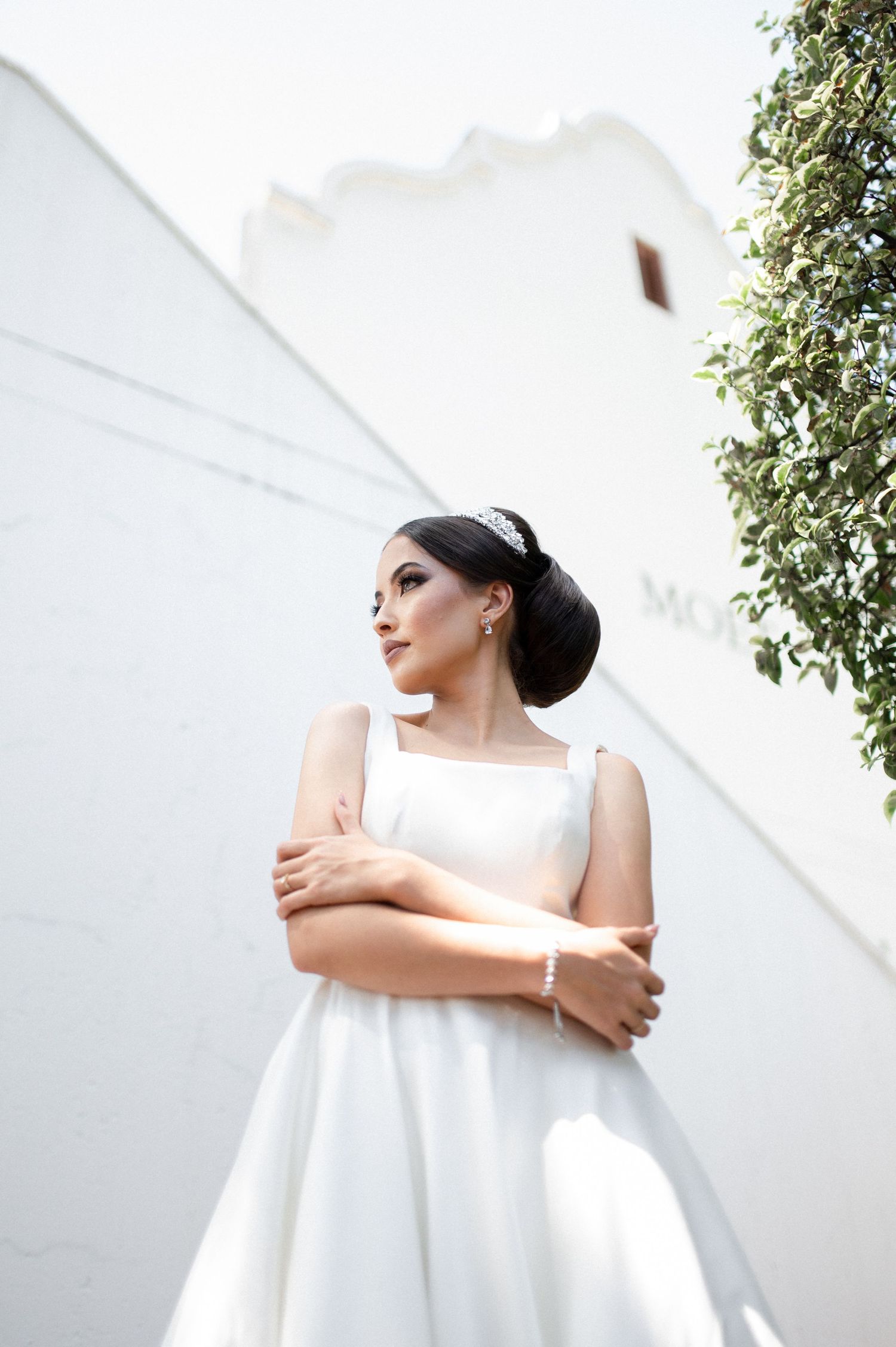 Elegant architectural bridal portrait featuring a minimalist white wedding gown.