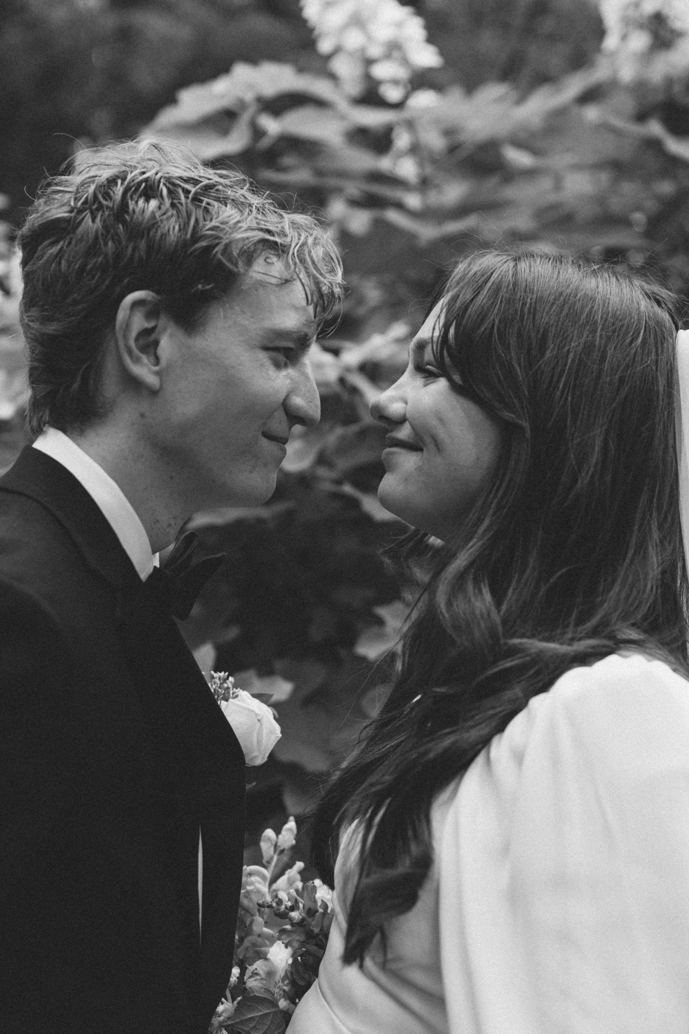 A romantic black and white photo sequence showing a couple in formal attire sharing tender moments together.