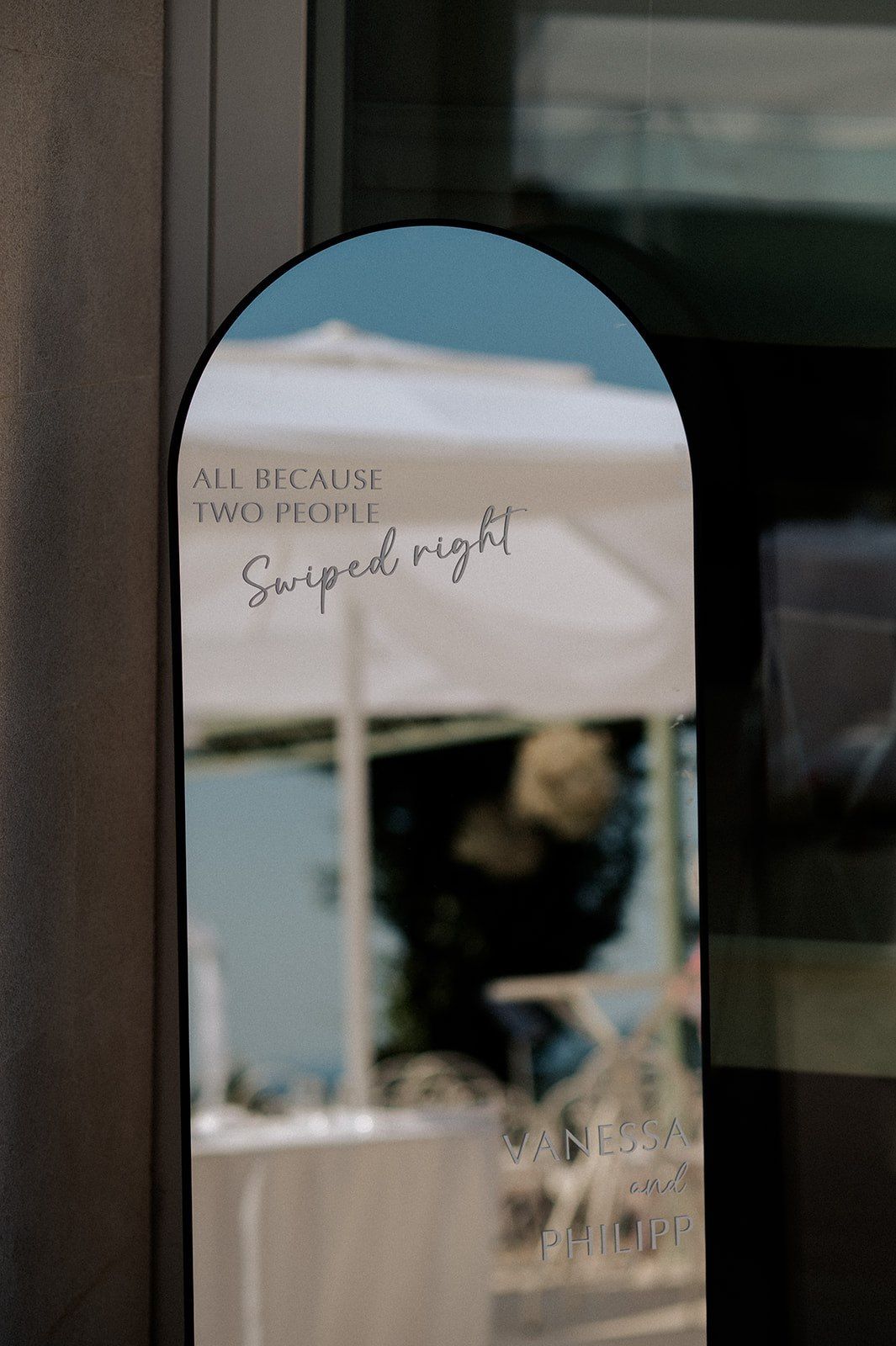Arched mirror with wedding quote 'All Because Two People Swiped Right' for Vanessa and Philipp.