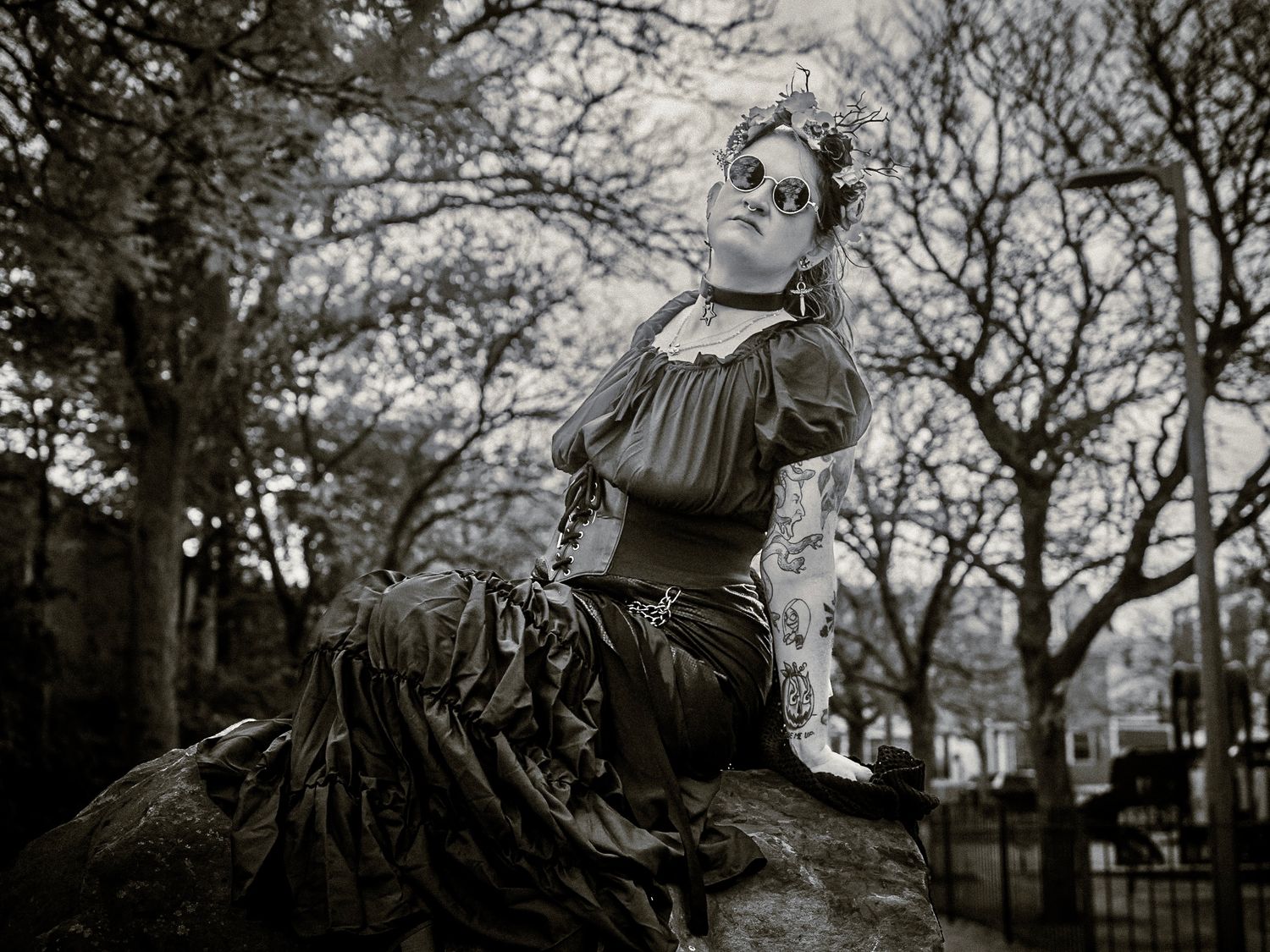 Vintage black and white photo of Victorian-style statue in garden setting.