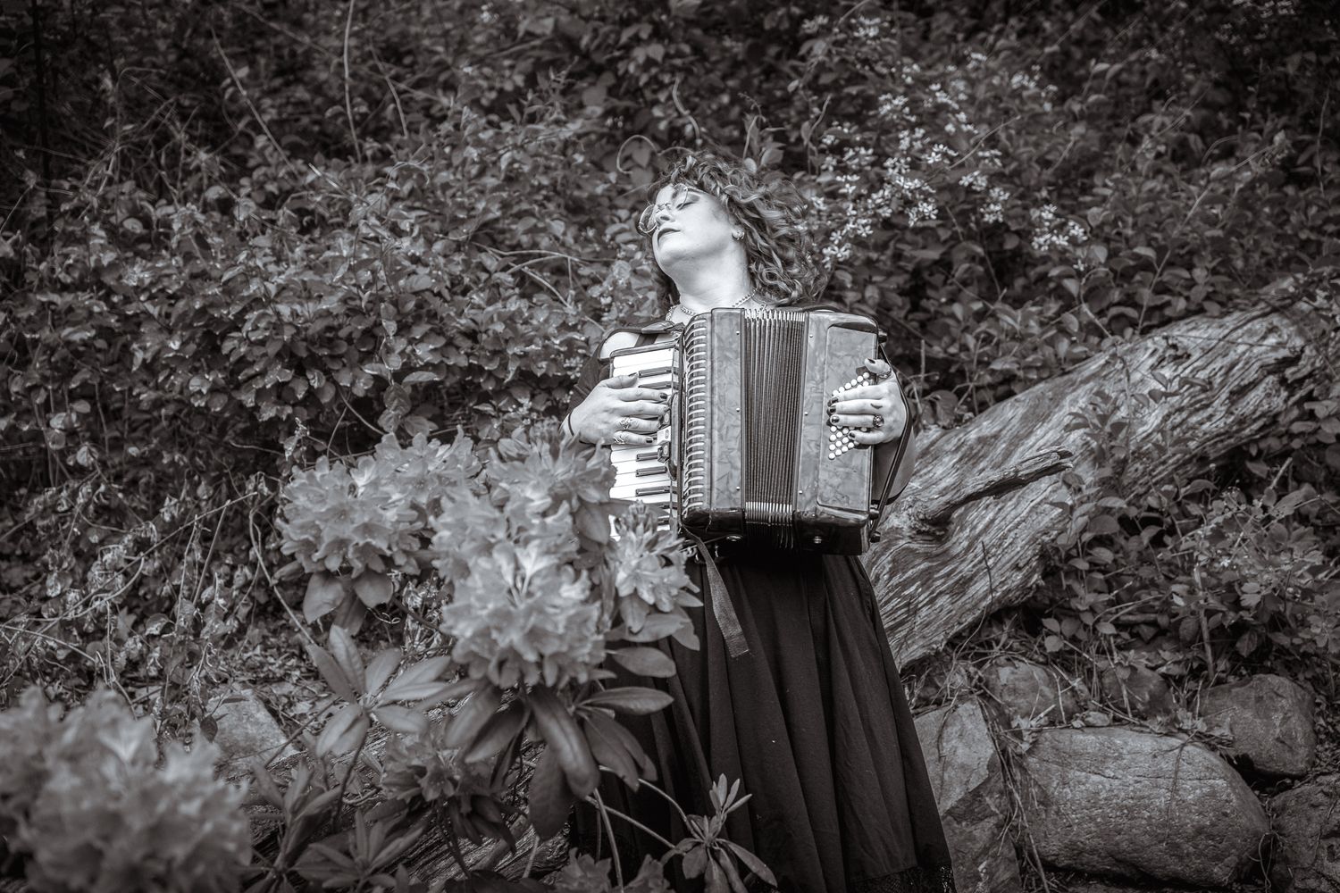 A series of black and white vintage photographs show an artist's creative process and various hand gestures during work.