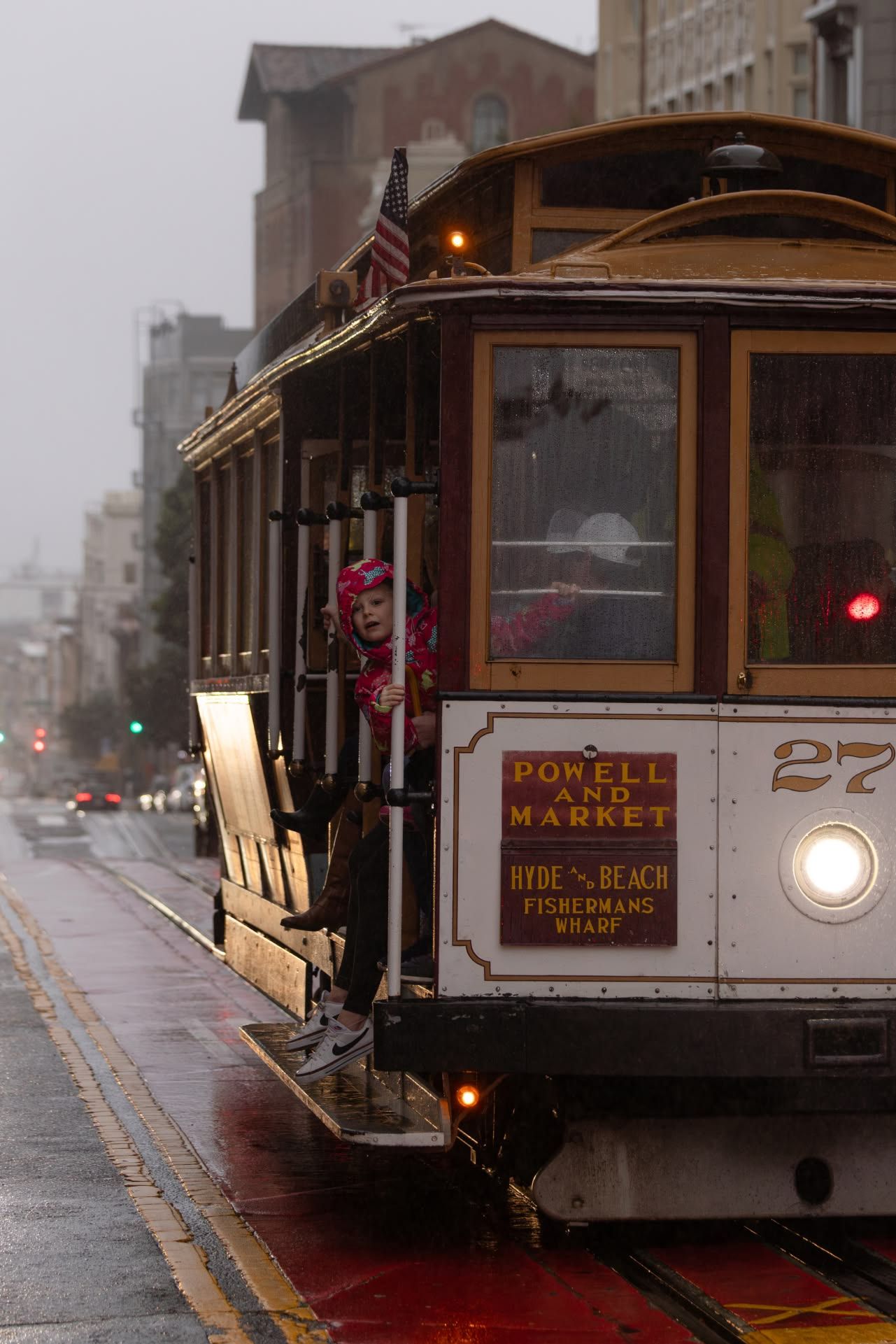 San Francisco cable car on Powell and Market Street on a rainy overcast day.