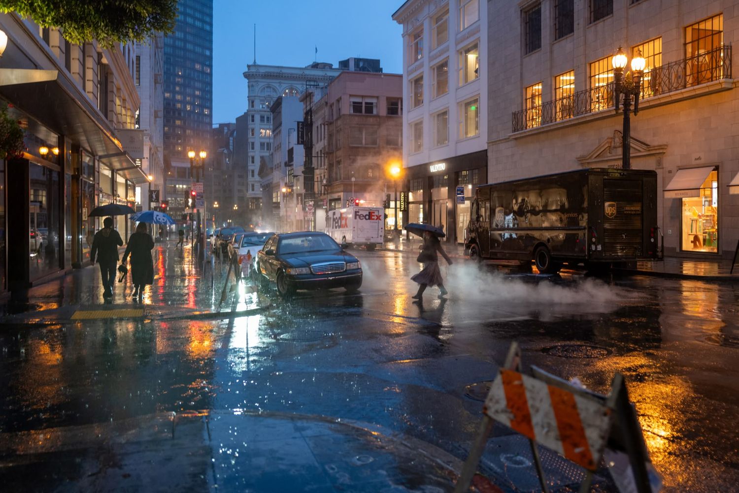 Rainy night city street scene with steam rising from manhole, wet reflections, umbrellas, and glowing urban lights.