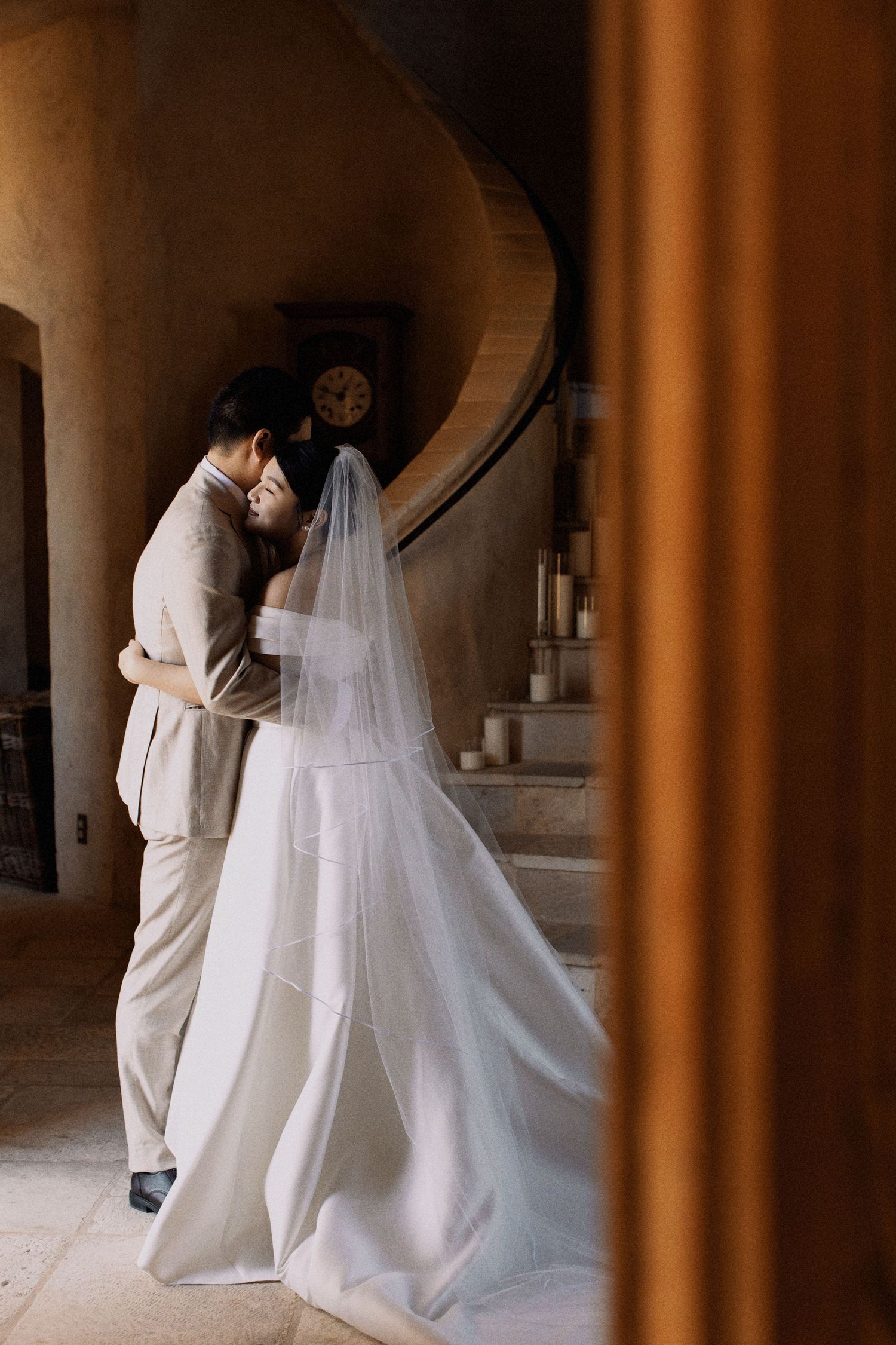 An intimate wedding moment captured between a couple on a vintage stone staircase.