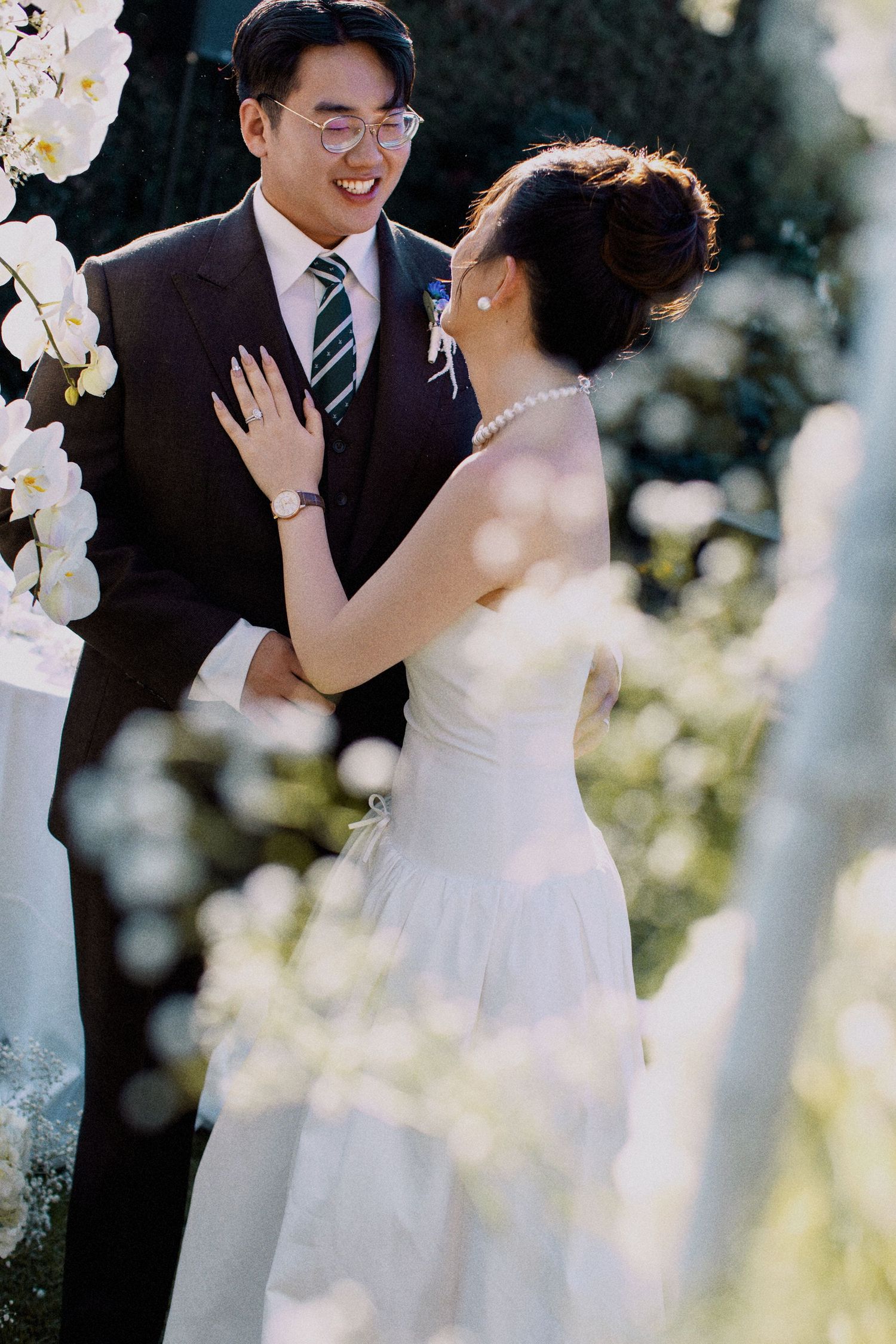 A candid moment of laughter between newlyweds during their garden ceremony.