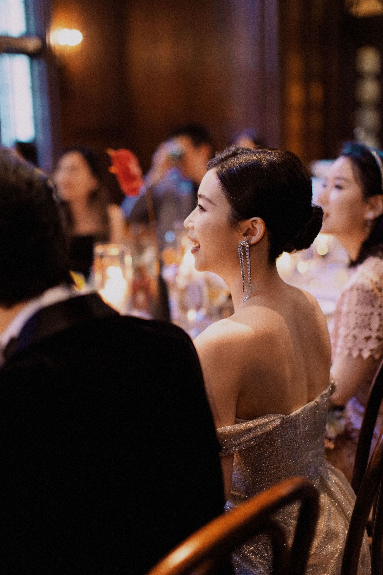 An elegant reception scene with guests in formal attire.
