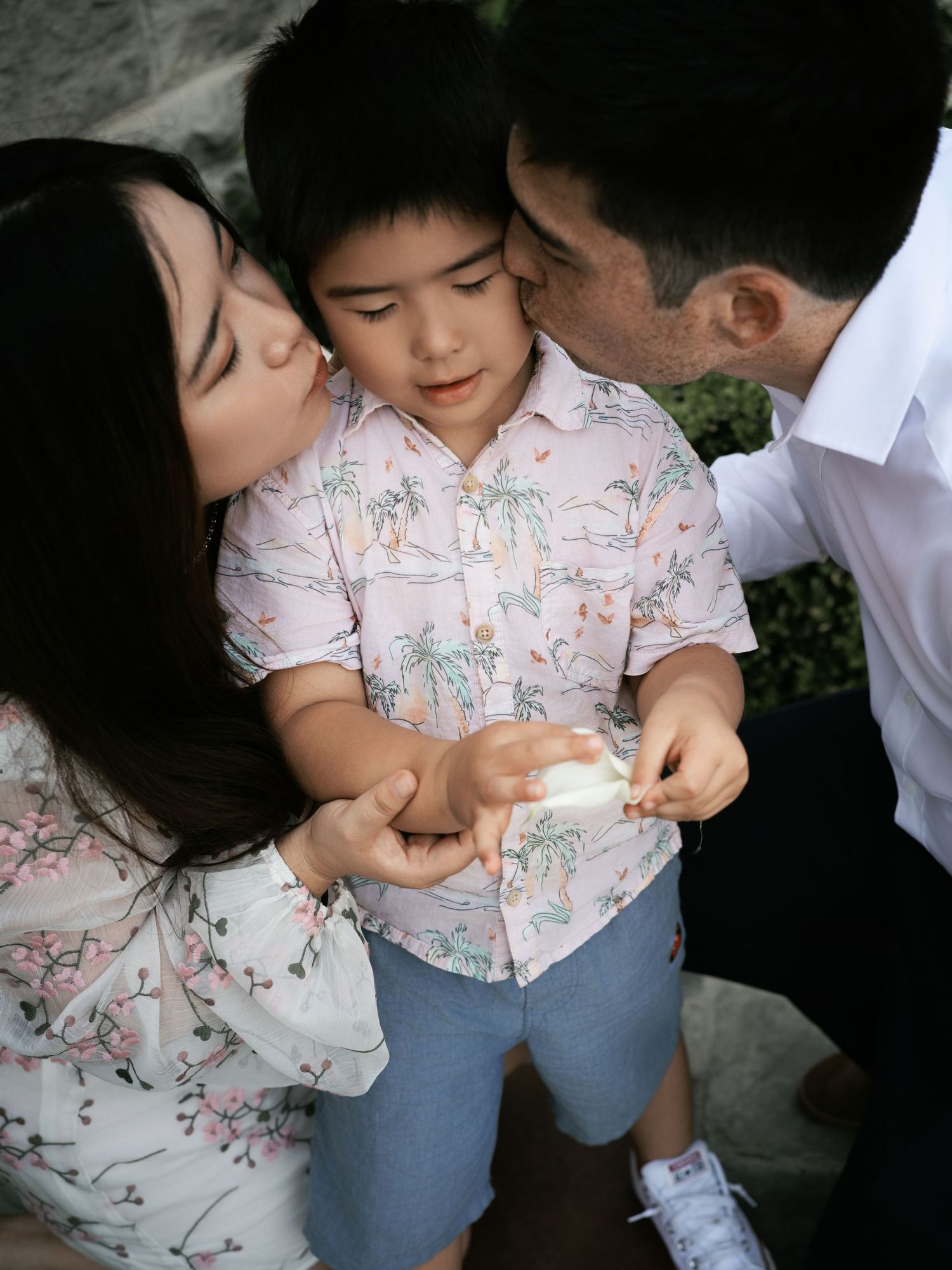 Intimate family moment sharing love and laughter outdoors.