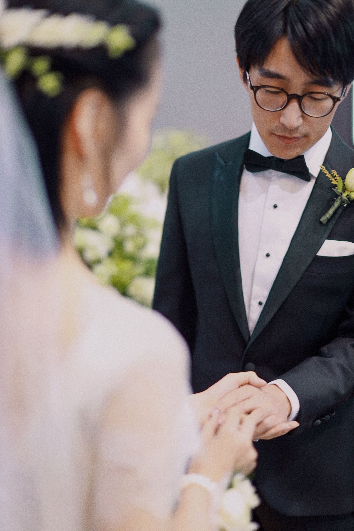 A tender moment during a wedding ceremony as couple exchanges rings.