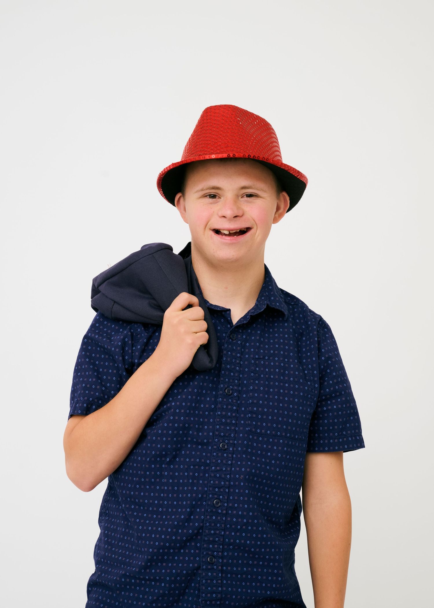 A sequence of photos showing someone in a navy blue polo and red cap against a white backdrop.