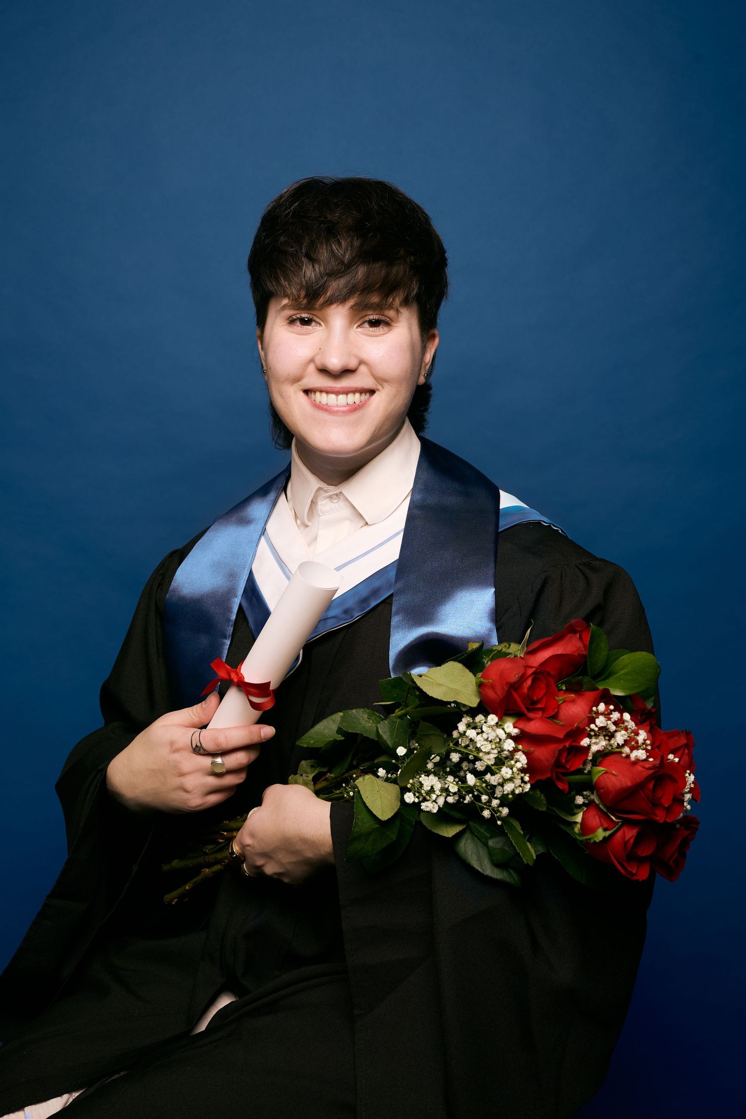A series of four photos showing someone in black holding red roses against a dark blue backdrop.