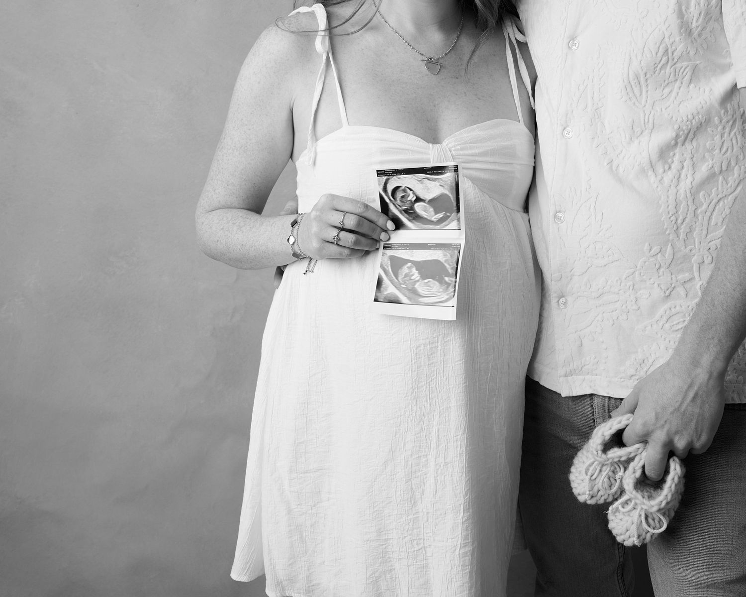 A black and white photo series showing intimate moments between a couple in white clothing.