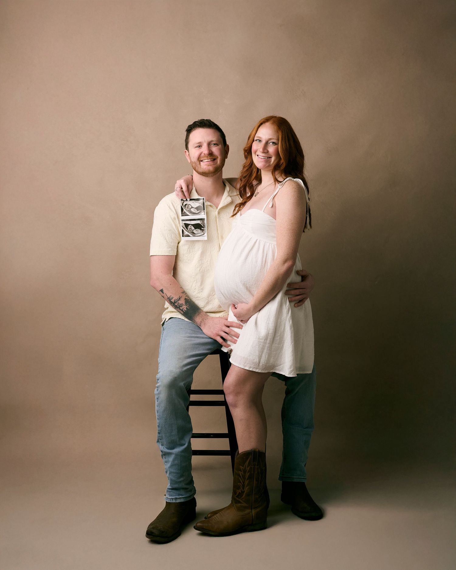 A maternity photo series showing a couple posing together against a brown backdrop in progressive stages of pregnancy.