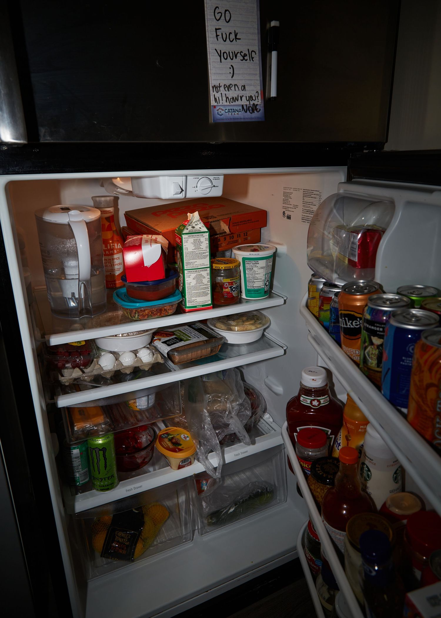 Inside view of a refrigerator stocked with various food items and beverages.