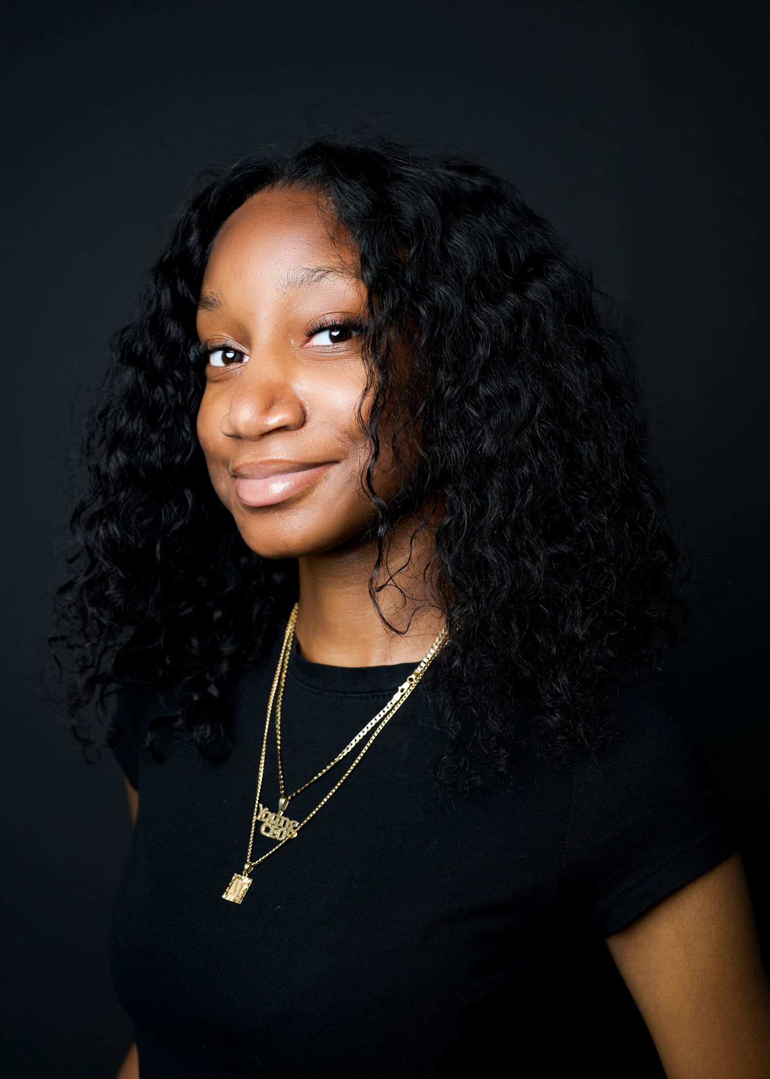 Against a dark background, a collection of portraits shows curly dark hair styled in different angles and poses.