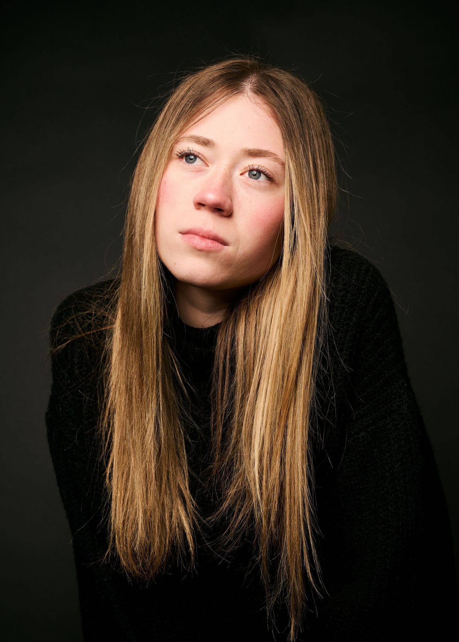 Multiple artistic portrait photos showing long blonde hair against dark background in moody lighting.