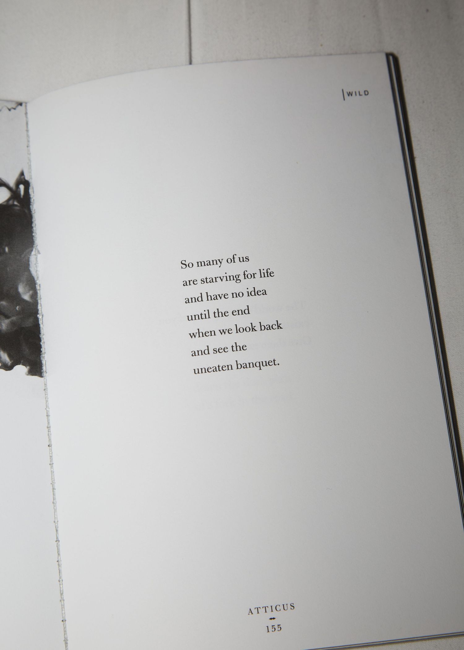 A black text quote printed on a white page of a book.